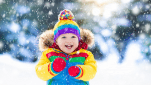 little boy playing in the snow