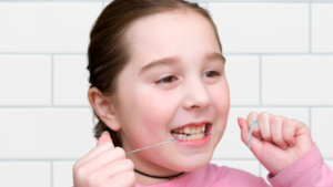 child flossing